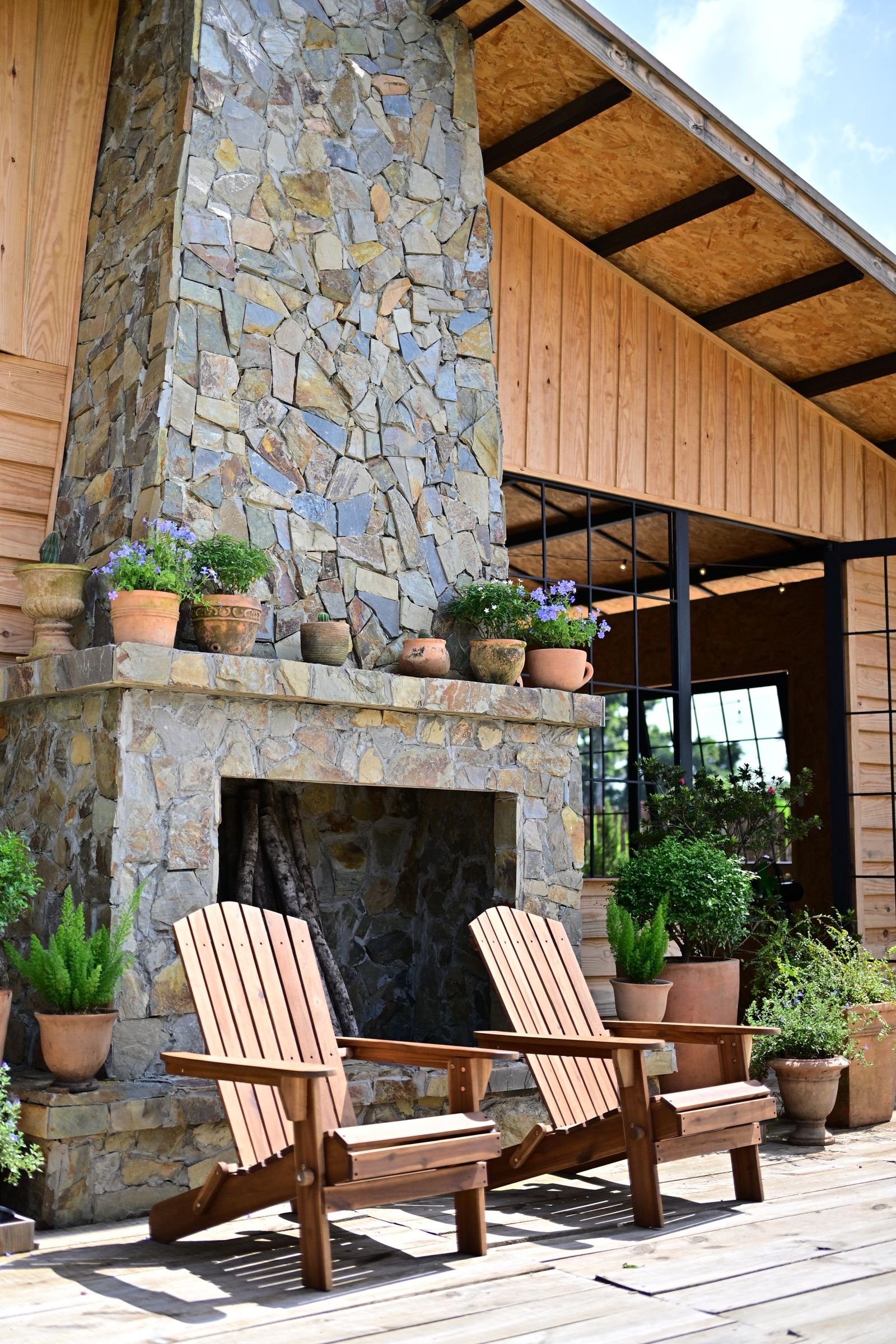 Masonry outdoor fireplace with planters on a patio